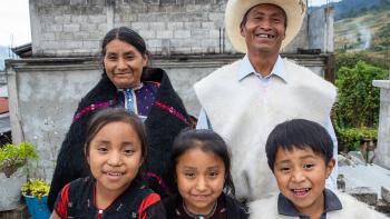 Camilo with his wife and three kids in front of their cement block Habitat home in picturesque Chiapas, Mexico.