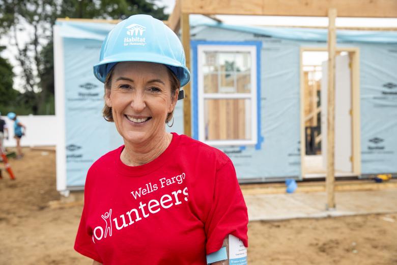 Mary Mack smiling on build site.